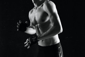 Fototapeta na wymiar young male boxer on black background
