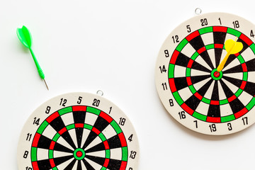 Goal achievement concept. Dartboard and arrows or dart on white background top view copy space