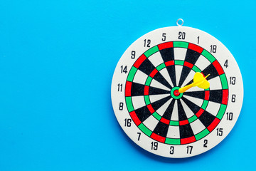 Darts game - simple sport for lesure time. Dartboard and arrows or dart on blue background top view...