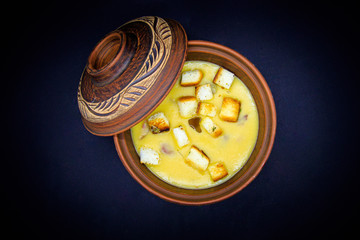 pea soup with croutons on black background