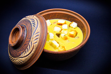 pea soup with croutons on black background