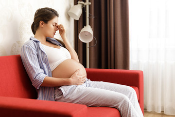 Young pregnant woman has painful headache