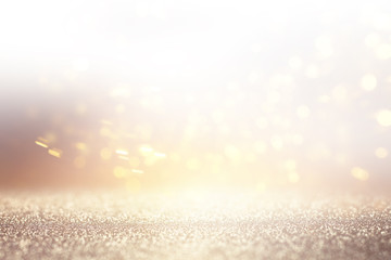 Naklejka premium abstract background of glitter vintage lights . silver, gold and white. de-focused