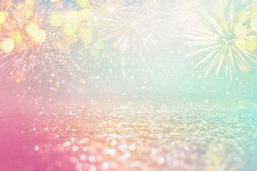 abstract gold, pink and mint glitter background with fireworks. christmas eve, 4th of july holiday...