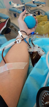 Arm of Young man during the blood donation in the hospital