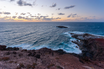 Sunrise over the Atlantic Ocean on rocky beach