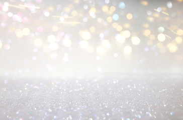 abstract background of glitter vintage lights . silver, gold and white. de-focused