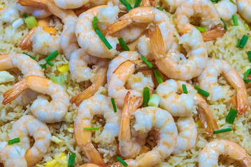 Shrimp fried rice and soy sauce with shrimp on top in the pan to make it look appetizing at the local market.