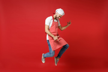 Crazy young male chef cook or baker man in striped apron white t-shirt toque chefs hat posing...