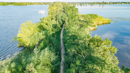 Aerial drone view of path on dam in polder water from above, landscape and nature of North Holland,...