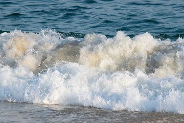Waves crashing the beach and rocks