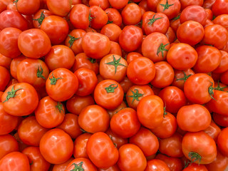 Flawless red tomatoes at grocery store for healthy concept background