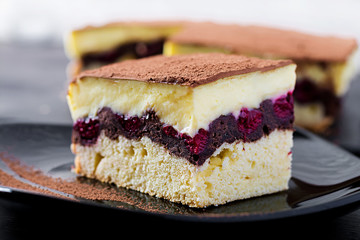 Cake cupcake with cherries, cocoa and custard.