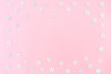 Christmas composition. Christmas snowflakes on pink background. Flat lay, top view, copy space