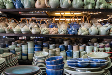 Bangkok, Thailand - Handcrafted pottery, teapots and dishes for sale at a stall in Chatuchak Weekend Market - obrazy, fototapety, plakaty