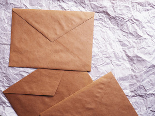 Envelope of Kraft paper lies on crumpled paper. Note from a paper on a cord of an envelope from...