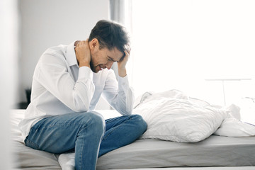 young man sitting on sofa at home