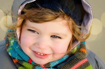 beautiful little girl on the beach in winter