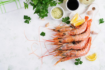 Raw wild Argentinian red shrimps/prawns  and ingredients for cooking. Delicious food. Keto / Paleo Diet. Top view, overhead