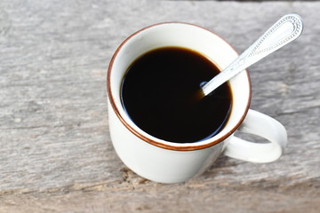 Close up a white coffee cup with heart shape on wood desk