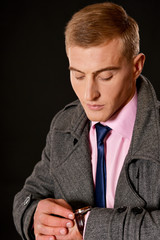 Close up portrait of young businessman checking time