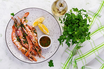 Grilled wild Argentinian red shrimps/prawns with parsley, oil, garlic and lemon. Delicious food. Keto / Paleo Diet. Top view, overhead