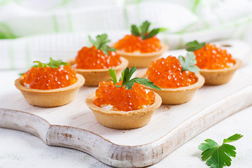 Tartlets with salmon red caviar and feta cheese. Sandwich for lunch. Delicious food.
