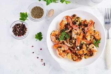Grilled shrimps. King prawn tails in orange-garlic sauce with parsley. Top view, copy space