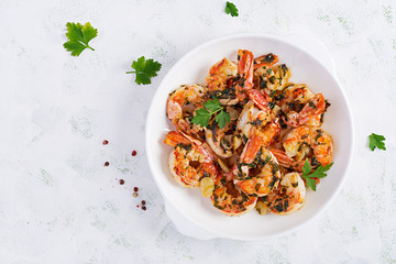 Grilled shrimps. King prawn tails in orange-garlic sauce with parsley. Top view, copy space
