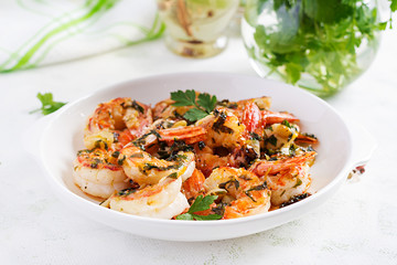 Grilled shrimps. King prawn tails in orange-garlic sauce with parsley.