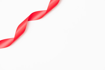 Curly red ribbons on white background