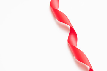 Curly red ribbons on white background