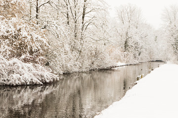water channel through snowy forest