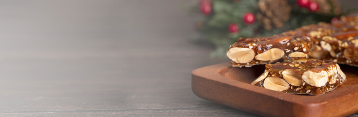 Turron guirlache, Hard nougat made with almond and caramel. Traditional Christmas sweet consumed in Spain.Banner with copy space