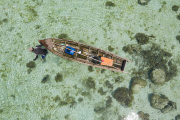 Aerial view of Sea Gypsy water village, island and the ocean with sky in Semporna, Sabah, Malaysia, Borneo.