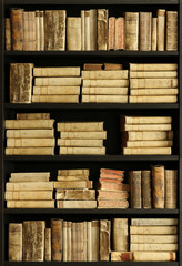 antique books on old wooden shelf.