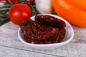Dried tomatoes in the bowl with olive oil