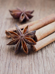 Dried anise and cinnamon on wooden background. Close up.