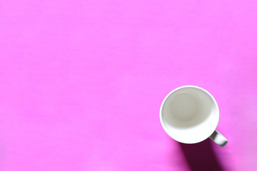 Fototapeta na wymiar white cup on pink background