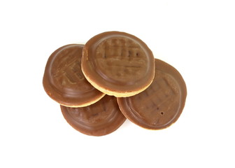Chocolate coated biscuit cakes with the orange filling isolated over the white background.