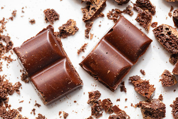 Sliced chocolat with crumbs on a white background close-up