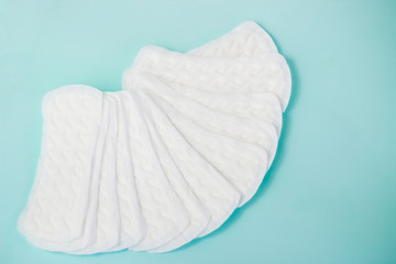 flat lay of feminine hygiene items. Details for critical women's days on a turquoise background. Gaskets for women, health