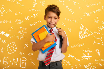 Child cries because he has a lot of school homework. Emotional expression. Yellow background