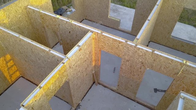 Construction of new and modern modular house. Walls made from composite wooden sip panels with styrofoam insulation inside. Building new frame of energy efficient home concept.