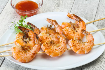 Grilled prawn skewer with sauce