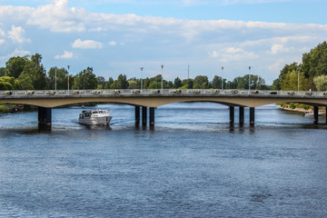Fototapeta na wymiar Karlstad bridge with tourist boat under the bridge in the river Klarälven, Sweden