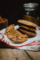 Freshly baked chocolate chip cookies on rustic wooden table