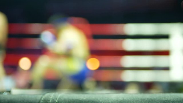 Defocus background of a Thai boxing fighter doing Thai boxing ( Muay Thai ) traditional pre-fight dance ( Wai Khru / Ram Muay ) 
