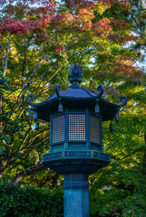 Japanese stone lantern at autumn garden