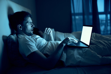 man sitting on sofa with laptop